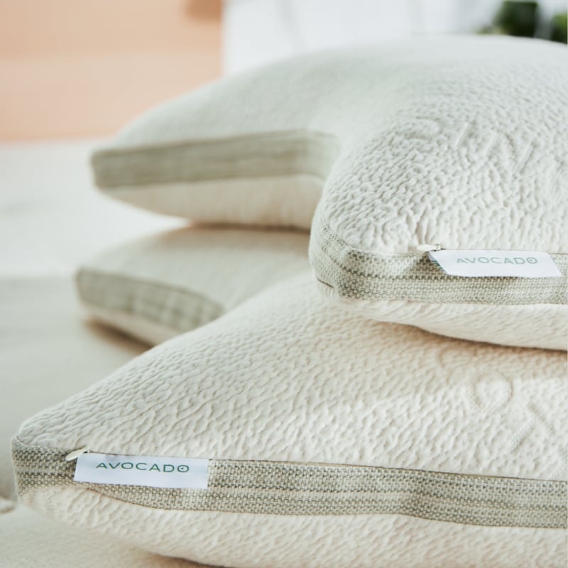 Pair of Avocado Side Sleeper Pillows on a bed
