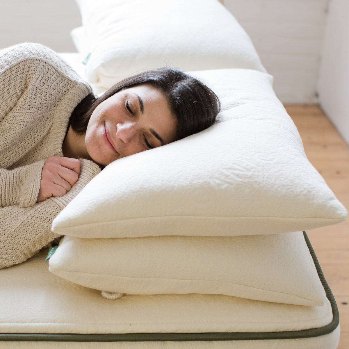 Sleeping on the Avocado Green Pillow in its GOTS-certified organic cotton cover
